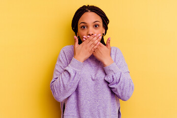 Young african american woman isolated on yellow background shocked covering mouth with hands.