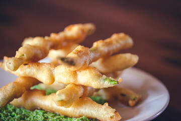 panko crusted asparagus dish with pesto served at a restaurant