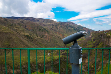 Binoculars, standing on the mountain, view of the gorge Garni.