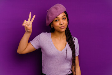 Young african american woman isolated on yellow background Young african american woman isolated on yellow background joyful and carefree showing a peace symbol with fingers.