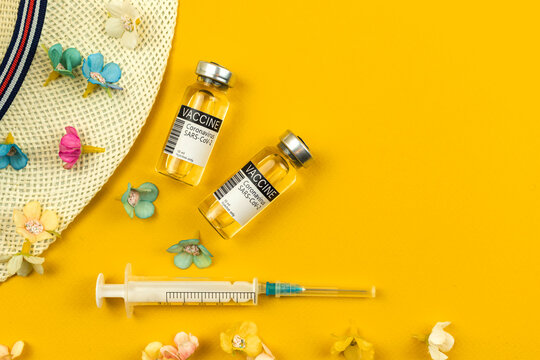 Summer Vacation During Covid Flat Lay Background With Vaccine Vials And Syringe, Safe Travel And Trip Concept, Top View Photo