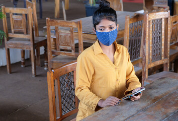 Young Indian female in a face mask during the COVID-19 pandemic