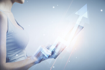 Double exposure of arrows hologram and woman holding and using a mobile device. Success concept.