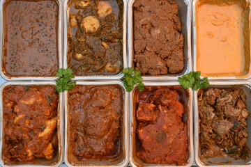 Indian curries Starting from the top row left to right are black lentils new potatoes with spinach diced mutton cod loin in coconut milk mango sauce stewed chicken beef strips spicy paneer and cabbage