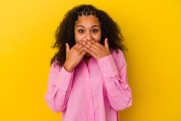 Young african american woman isolated on yellow background shocked covering mouth with hands.