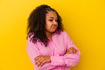 Young african american woman isolated on yellow background tired of a repetitive task.