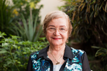 grandma in the garde, old lady in the garden, old lady smiling