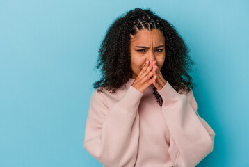 Young african american woman isolated on blue background making up plan in mind, setting up an idea.