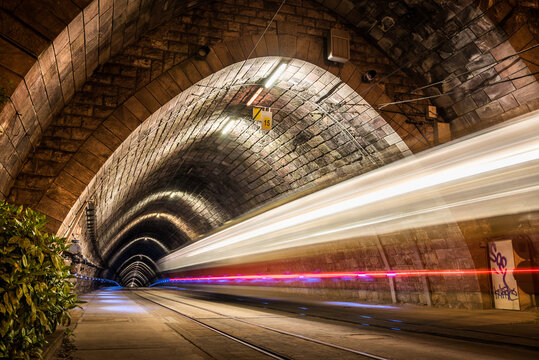 Illuminated Tramway Tunnel with Tram Light Trails at Night in Bratislava, Slovakia