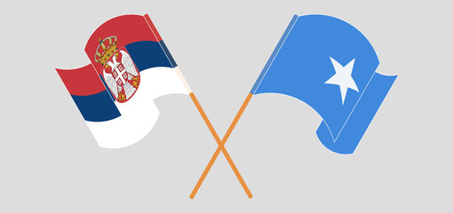 Crossed and waving flags of Serbia and Somalia