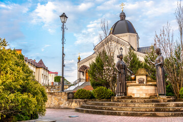 Truskavets, Ukraine - April 2021: Greek Catholic Church of St. Nicholas and Sculpture "Jesus Christ and the Samaritan Woman"