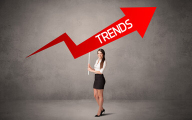 Fototapeta premium Young business person in casual holding road sign