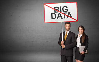 business person holding a traffic sign