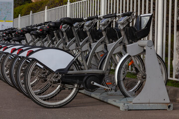 Walking bikes are in a row at the bike rental point
