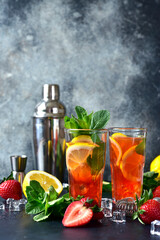 Cold summer cocktail with fresh strawberry, lemon and mint.