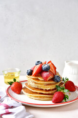 Hot homemade delicious pancake with fresh strawberry and honey.