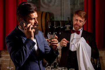 Alcohol serving. Barman at counter. Bartender working and takecare customer. Wine for customer.