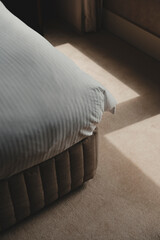 Neatly folded bed corner – abstract detail shot.