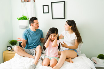 Upset kid listening to her parents discussing