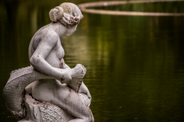 Fototapeta na wymiar statue of a person in a lake