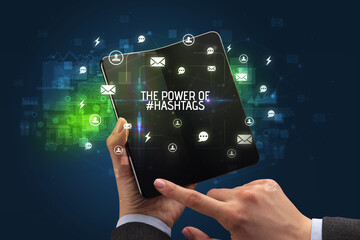 Businessman holding a foldable smartphone, social media concept concept