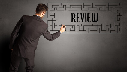 young businessman drawing maze concept