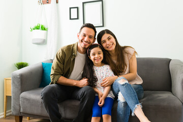 Loving parents and kid smiling at the camera
