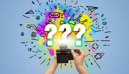 Close-up of a hand holding digital camera with abstract drawing concept