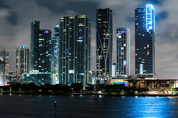 Miami Florida at sunset, skyline of illuminated buildings and Macarthur Causeway bridge. Miami night.