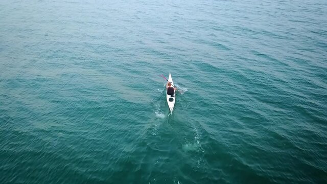 Aerial view of lonely kayaker in sea