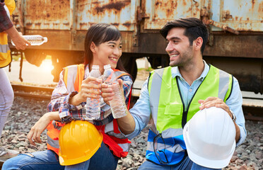 Industrial workers sit and drink water.