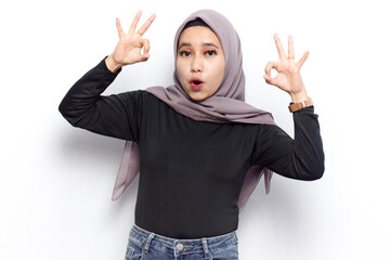 OK sign gesture of Young beautiful muslim asian women dress Veil(Hijab) and black shirt isolated on...