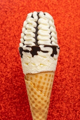 fresh vanilla flavor ice cream cone with chocolate on a red bling background
