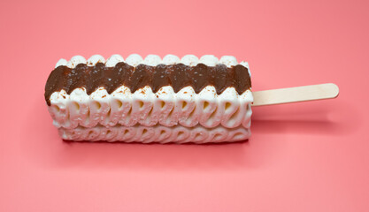 angle view vanilla and chocolate flavor popsicle on a pink background