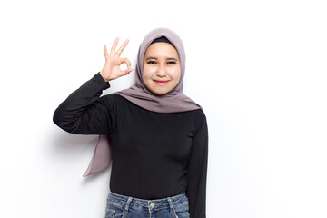 OK sign gesture of Young beautiful muslim asian women dress Veil(Hijab) and black shirt isolated on white background