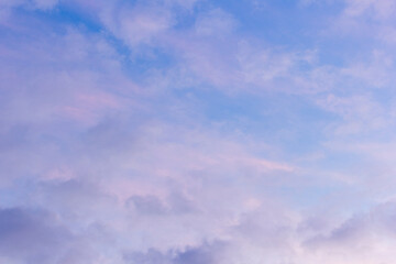 Sunset sky with floating clouds .beautiful cloud illuminated by the sun .concept background sky replacement .blue pink orange colors.
