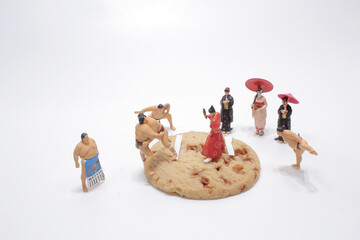 a mini figure of sumo wrestler on biscuit