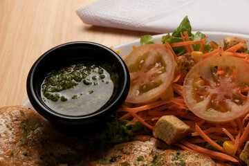green sauce for grilled meat in black bowl