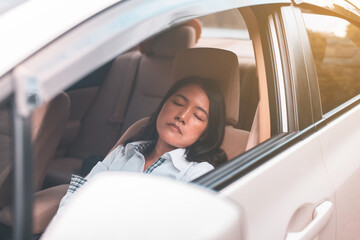 Woman take a nap on car during on the way,Safety and driving concept,Women sleeping on vehicle