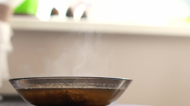 Steam coming out of a plate with a hot cooked dish close-up