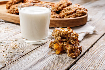Homemade oatmeal cookies and glass milk. Homemade gluten and sugar free recipe. Rustic wooden background and linen napkin. Delicious and healthy sweets. Breakfast. Copy space