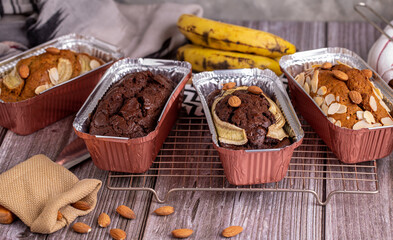 Homemade chocolate banana bread topping with almonds on foil cup.
