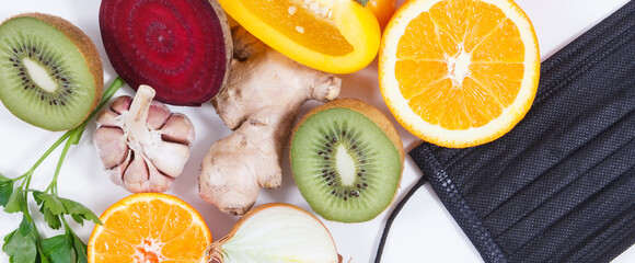 Fresh fruits with vegetables as source natural vitamins and protective mask. Strengthening immunity in times of epidemics Covid-19