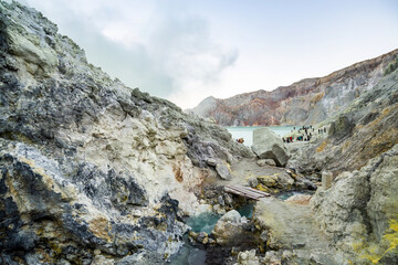 Rock wall and sulphur mining in Ijen crater in the morning in Kawah Ijen volcano Landmark from East Java Indonesia