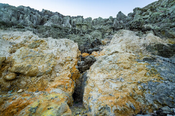 Rock wall and sulphur mining in Ijen crater in the morning in Kawah Ijen volcano Landmark from East Java Indonesia