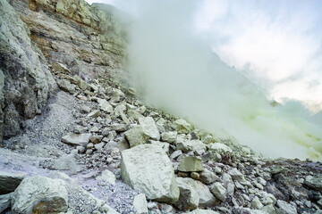 Rock wall and sulphur mining in Ijen crater in the morning in Kawah Ijen volcano Landmark from East Java Indonesia