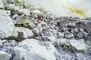 Ijen volcano crater and sulphur mining. Beautiful Landscape mountain and green lake with smoke sulfur in the morning in a Kawah Ijen volcano. Beautiful landmark from East Java, Indonesia
