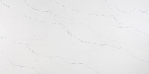 An off-white marble looking quartz slab with grey veins that move in a wave-like direction