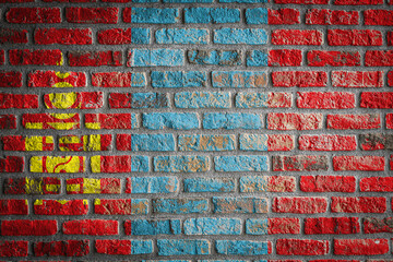 National flag of Mongolia depicting in paint colors on an old brick wall. Flag  banner on brick wall background.