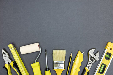 set of working tools for construction or home repair works on dark grey background. flat lay.